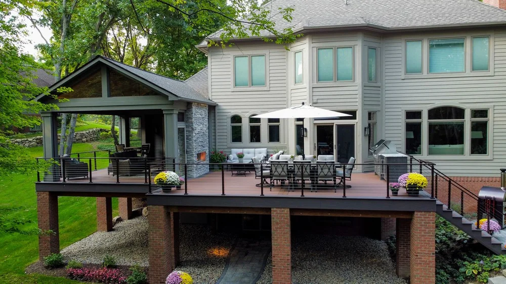 Composite deck designed to match home size by Decked Out Builders